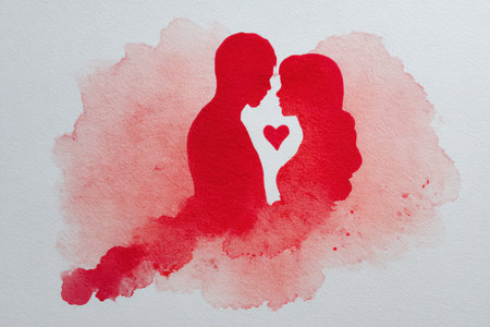 A red watercolor wash forms the silhouette of a couple with a heart symbol, representing an abstract love concept. The soft lighting enhances the romantic and artistic feel.の素材