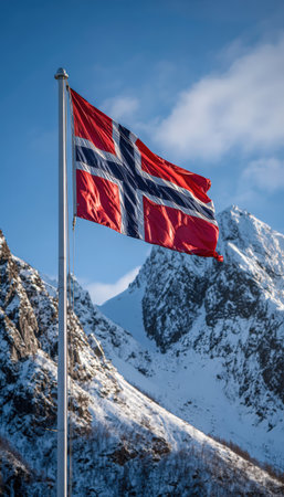 The Norwegian flag waves prominently on a pole, set against a backdrop of snow-covered mountains and a clear blue sky, capturing the essence of Nordic beauty and rugged atmosphere.の素材