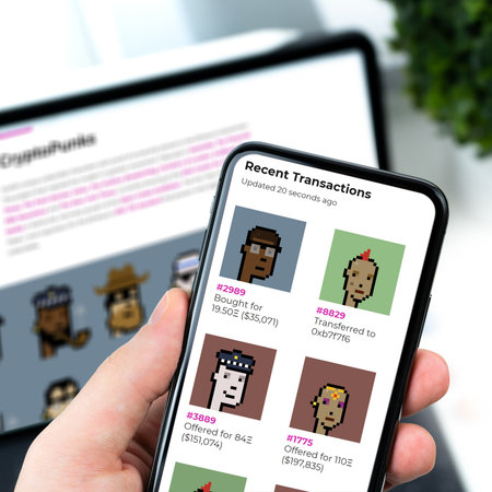 NY, March 11, 2021, the picture represents the webpage of Larvalabs on the homepage displayed on a smartphone, in the background the Larvalabs webpage on an iPad.のeditorial素材