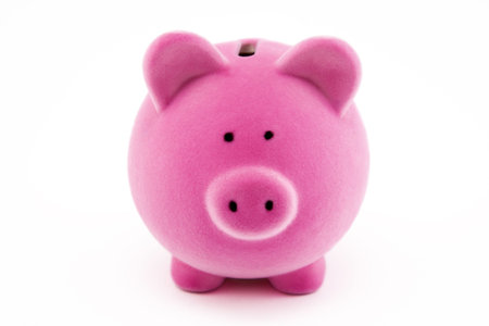 Pink piggy bank isolated on whiteの写真素材
