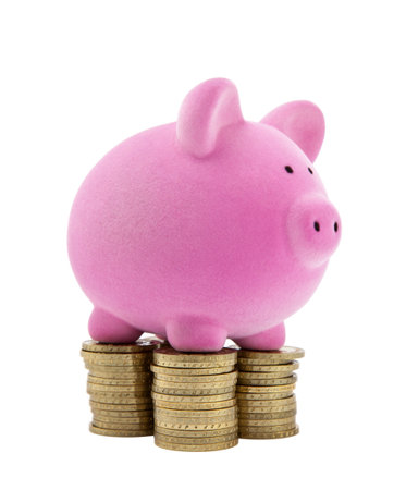 Piggy bank on stacks of coins の写真素材