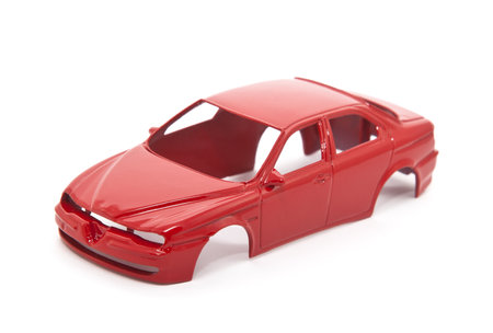 Red toy car body on white backgroundの写真素材