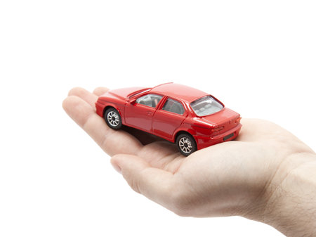 Hand holding a small red car. の写真素材