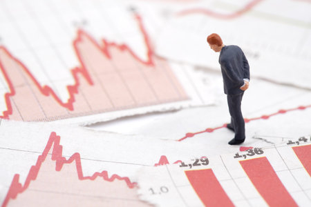 Financial crisis. Figure of businessman on financial chartsの写真素材