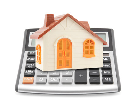 Small orange toy house on calculatorの写真素材