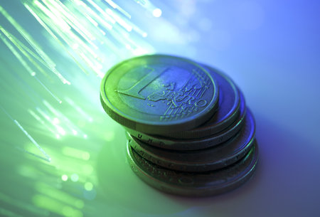 Euro coins on fiber optics backgroundの写真素材