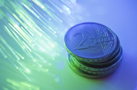 Euro coins on fiber optics backgroundの写真素材