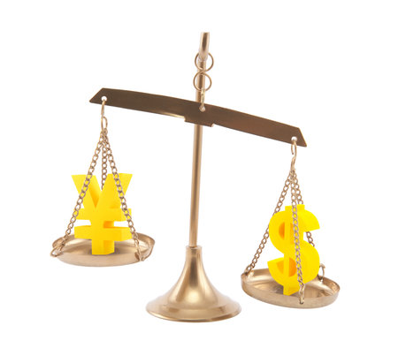 Yen and Dollar signs on scales isolated on whiteの写真素材