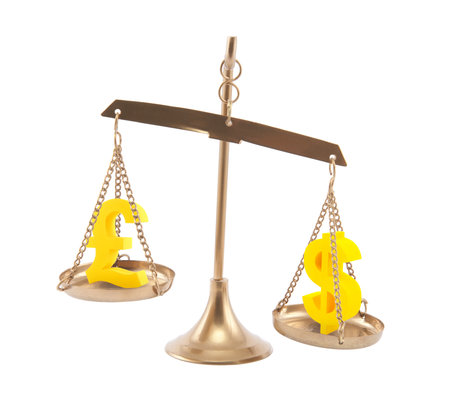 Pound and Dollar signs on scales isolated on whiteの写真素材