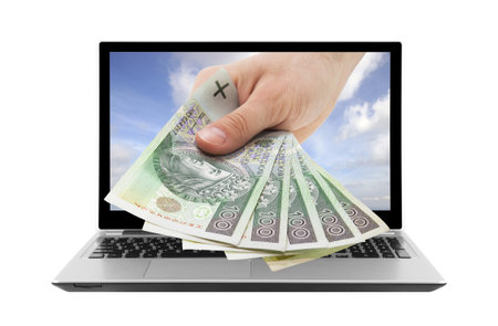 Laptop and hand with polish money  Clipping path included の写真素材