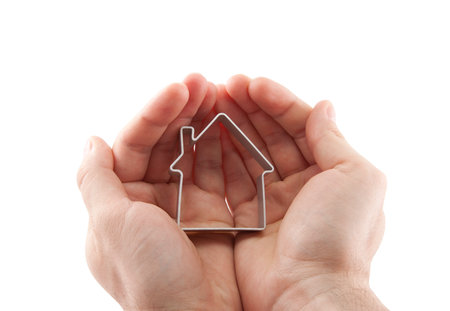 House in hands isolated on white with clipping pathの写真素材