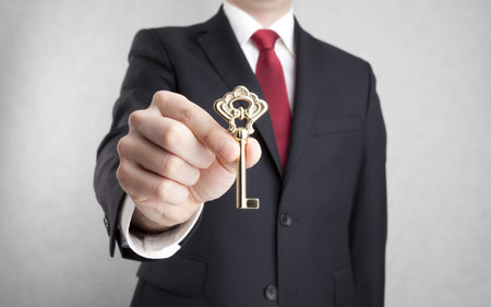 House key in businessman handの写真素材