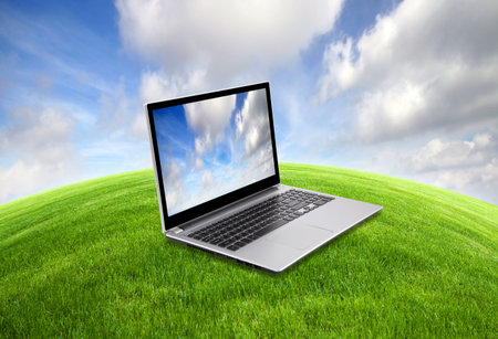 Laptop on green grassの写真素材