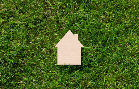 Cardboard house on green grassの写真素材