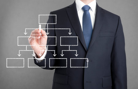 Businessman drawing diagram with chalkの写真素材