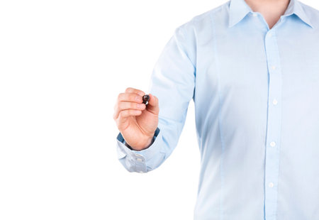 Young man writing with black marker on white background. Clipping path included.の写真素材