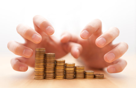 Greed for money. Hands grabbing coins.の写真素材