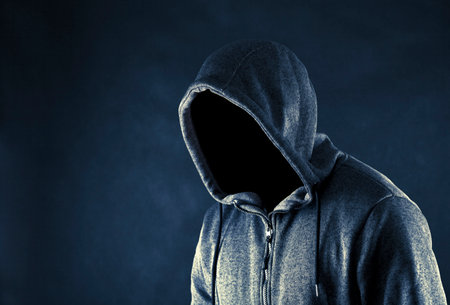 Hooded man in the darkの写真素材