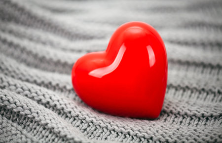 Red heart on knitted wool backgroundの写真素材