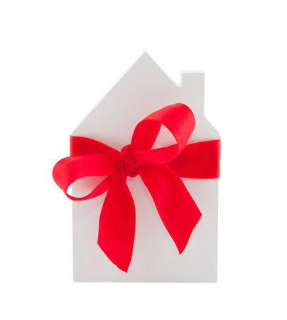 House with red ribbon isolated on white background with clipping pathの写真素材