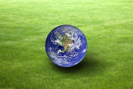 Planet Earth on green grass. Earth Day concept. Earth image provided by Nasa.の写真素材