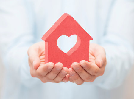Small house with heart in handsの写真素材