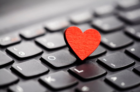 Small red heart on keyboard. Internet dating concept.の写真素材