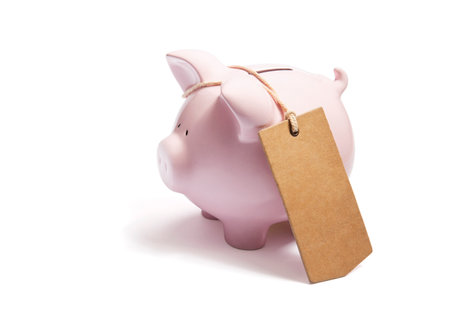 Piggy bank with blank tag tied with string.の写真素材