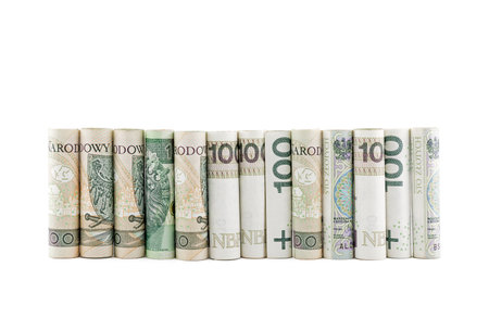 Polish banknotes rolled up isolated on white backgroundの写真素材