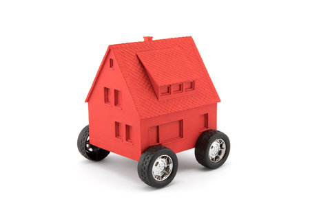 Red house on wheels isolated on whiteの写真素材