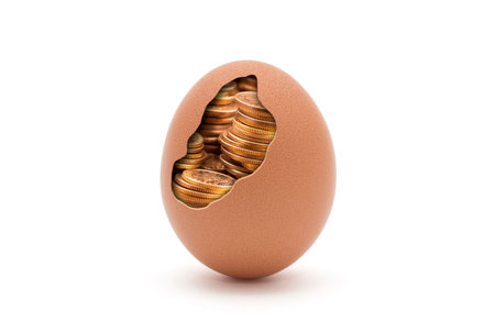Egg with golden coins isolated on white with clipping path