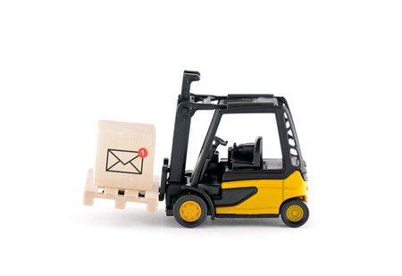 Yellow forklift with new email graphic on wooden blockの写真素材