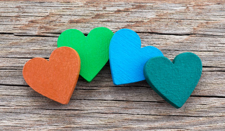 Colorful hearts on wooden backgroundの写真素材
