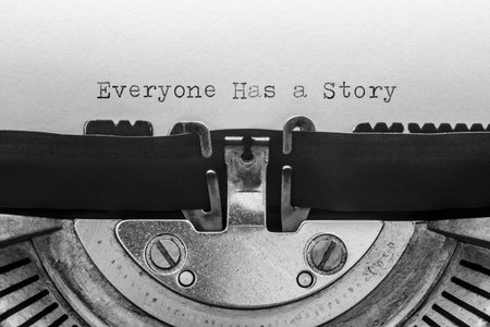 Everyone has a story typed on a vintage typewriterの写真素材