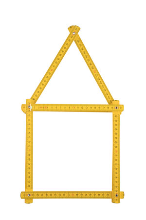 Yellow meter ruler folded as house isolated on white backgroundの写真素材