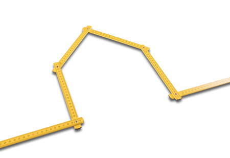 Yellow meter ruler folded as house on white backgroundの写真素材