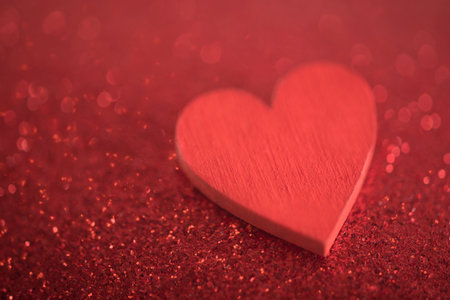 Red heart on glitter background in love conceptの写真素材