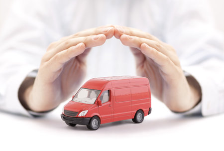 Transport red van car protected by handsの写真素材