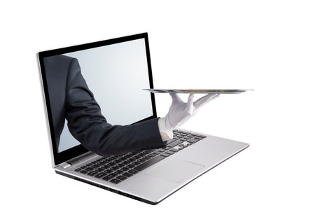Waiter holding empty silver tray. Laptop screen, isolated on whiteの写真素材
