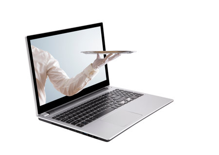 Waiter holding empty silver tray with laptop screen isolated on whiteの写真素材