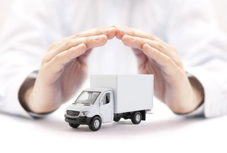 Cargo delivery truck protected by handsの写真素材