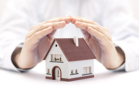 House miniature covered by handsの写真素材