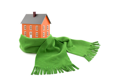 Orange house wrapped in a scarf isolated on whiteの写真素材