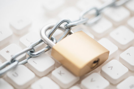 Security concept with metal padlock and chain on computer keyboardの写真素材