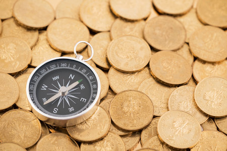 Financial concept with coins and compassの写真素材