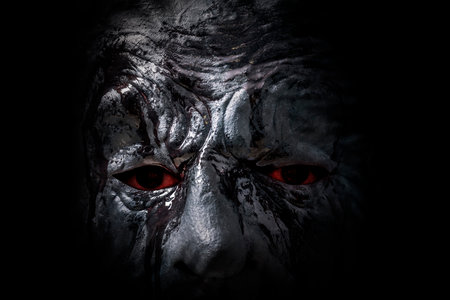 Scary figure with mask in the dark, macro shotの写真素材