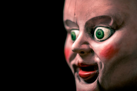 Creepy doll head in the darkの写真素材