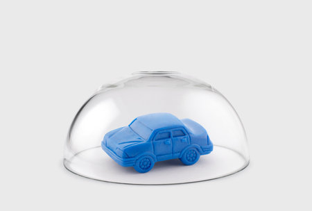 Blue toy car protected under a glass domeの写真素材