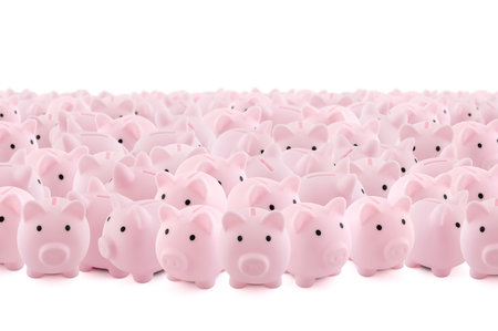 Large group of pink piggy banks on white backgroundの写真素材