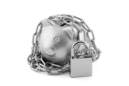 Silver piggy bank secured with padlock isolated on whiteの写真素材